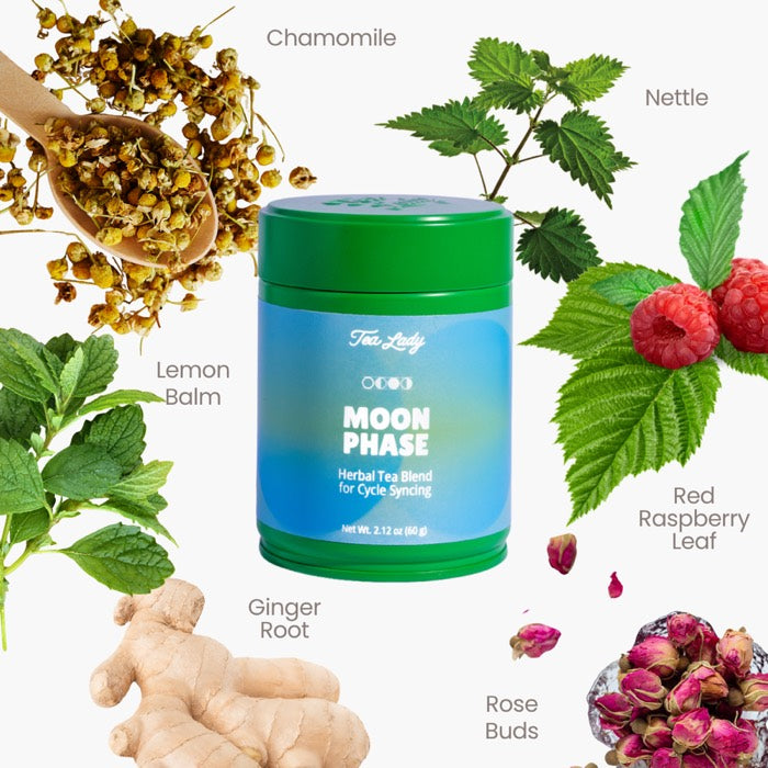Moon Phase Tea tin surrounded by chamomile, nettle, raspberry leaf, lemon balm, ginger root and rose buds